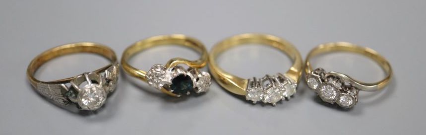 Four assorted 18ct and gem set rings,
